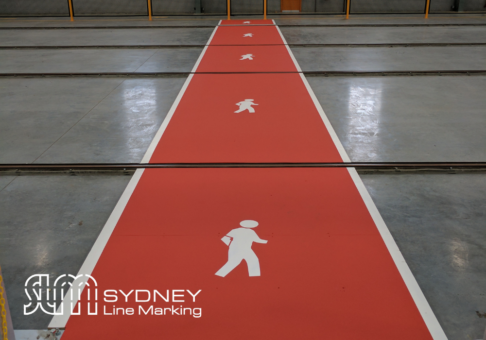 Red Walkway with white walking man symbol done by Sydney Line marking